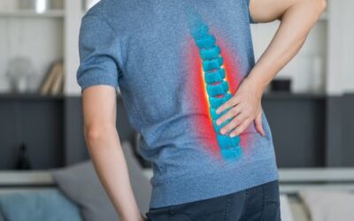 Doctor explaining herniated disc causes and treatment to a patient with back pain